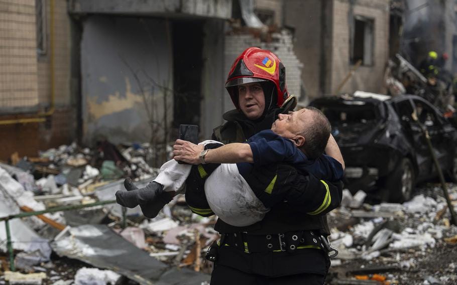 A firefighter carries a man from a damaged residential building after a Russian missile strike, in Kyiv, Ukraine, Tuesday, Jan. 2, 2024.