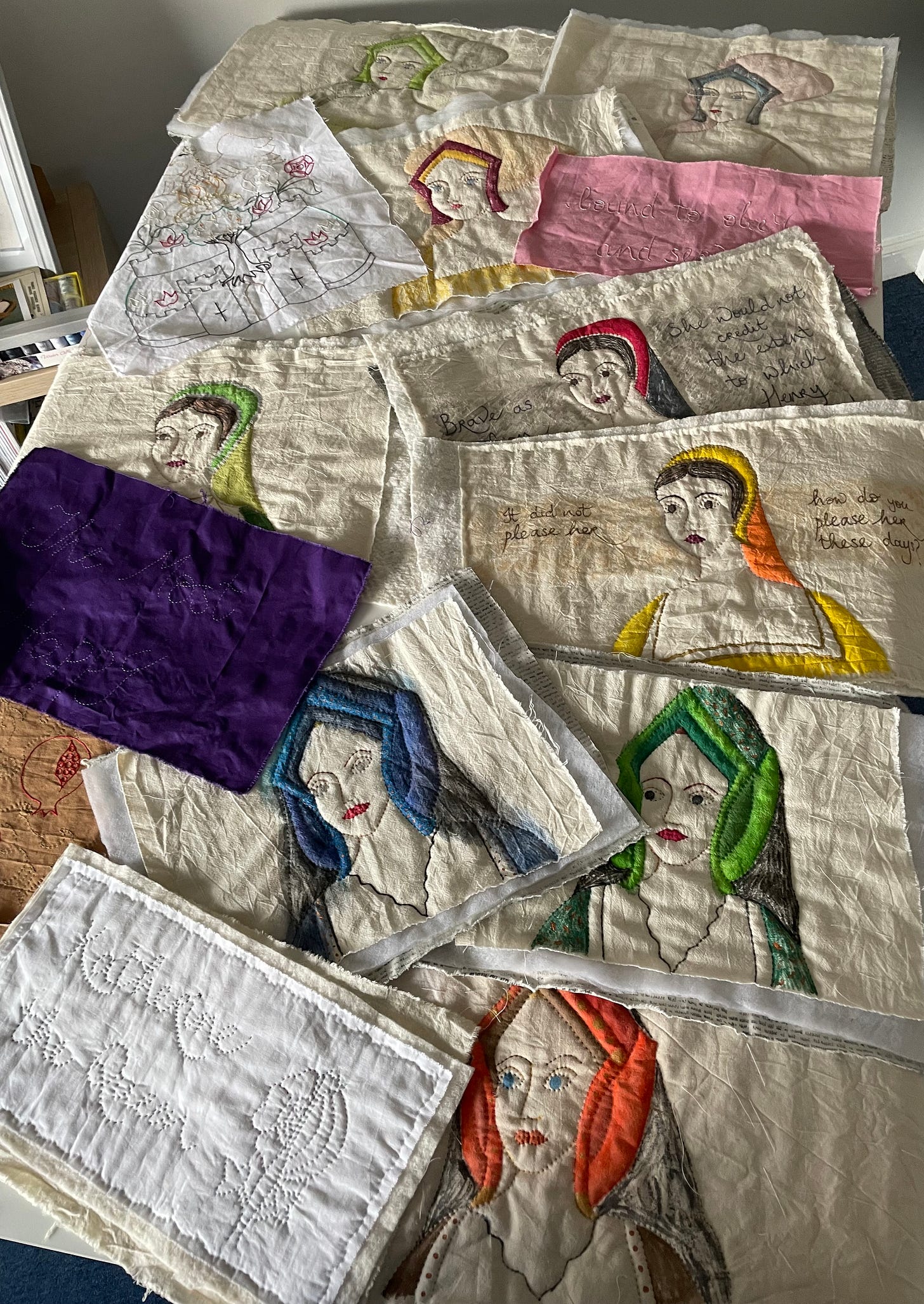 Pages from The Book of Queens, laid out prior to binding. Three images of Katherine, Anne and Jane are visible.