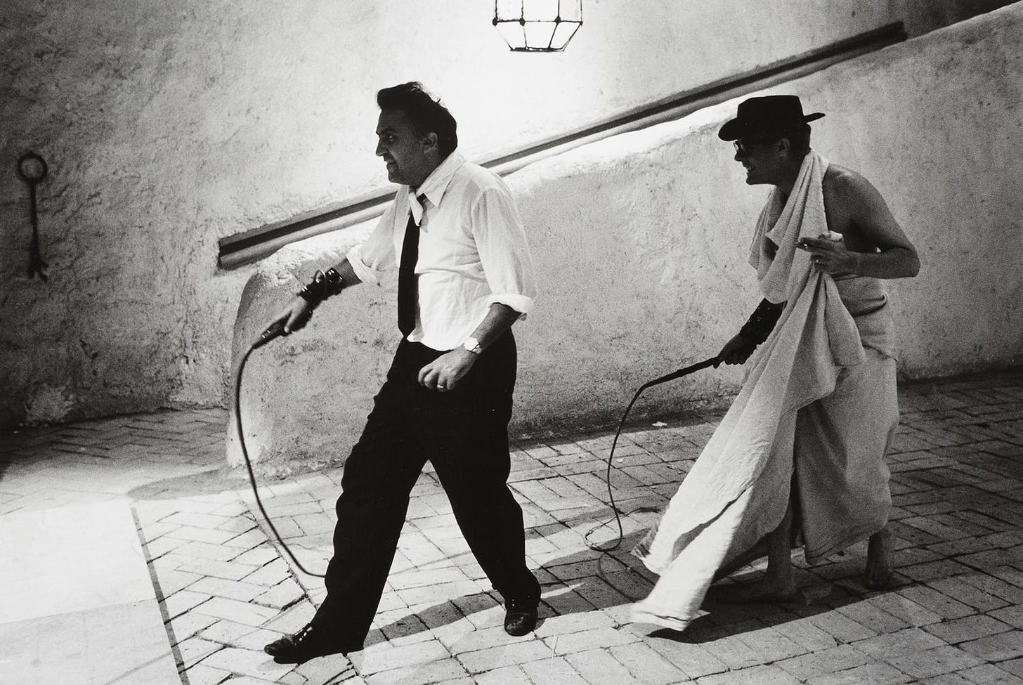 Federico Fellini and Marcello Mastroianni wield whips on set of "8 1/2" (1963)