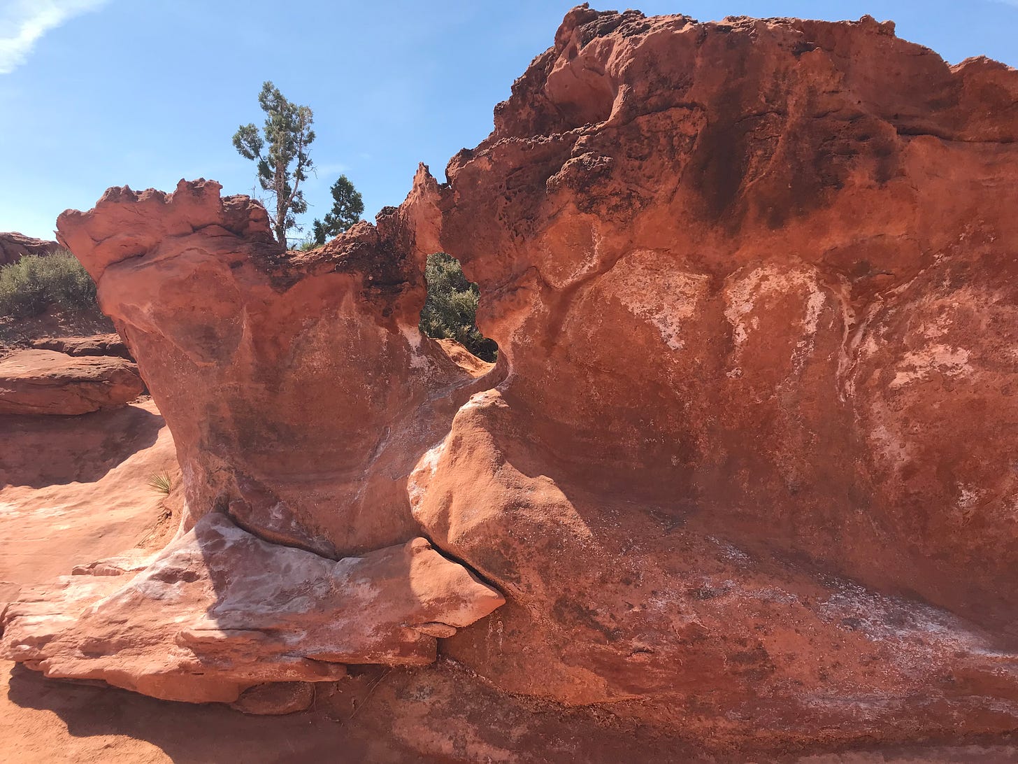 A close-up of red cliffs with a blue sky background.