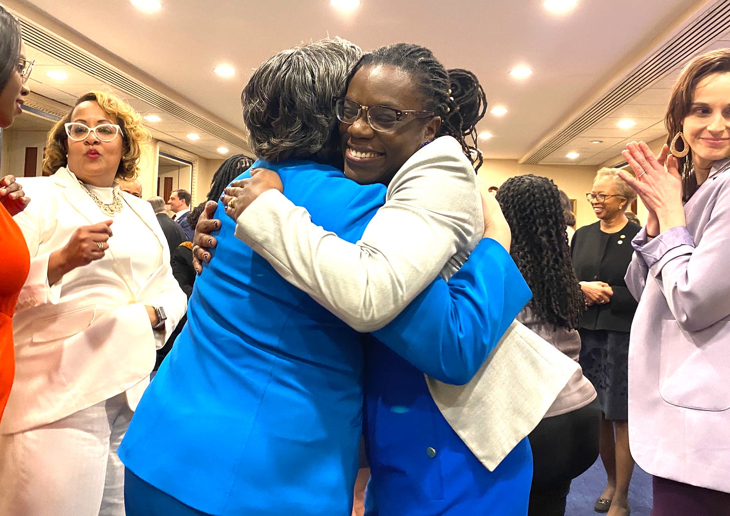 Keren Charles Dongo hugs Rep. Jennifer McClellan