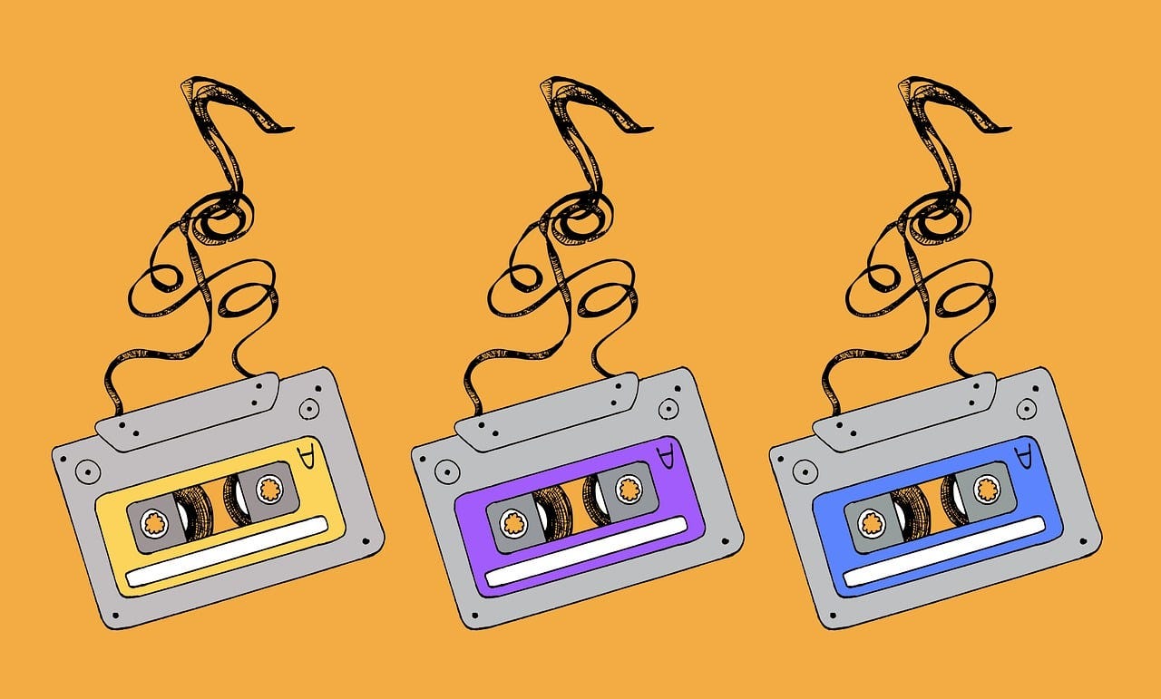three cartoon cassette tapes on an orange background