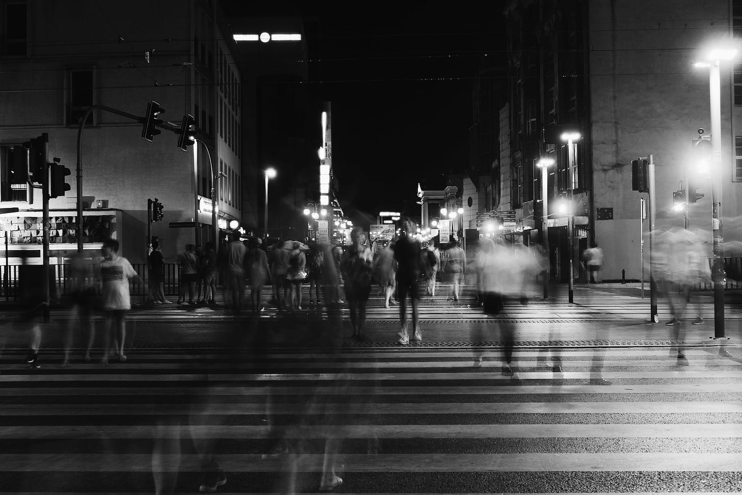 A timelapse black and white image of people in a city.
