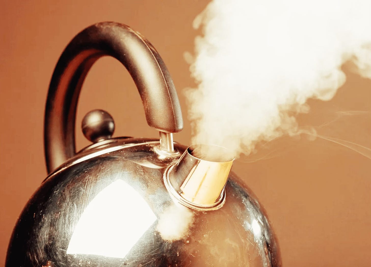 tea kettle with steam coming out of spout