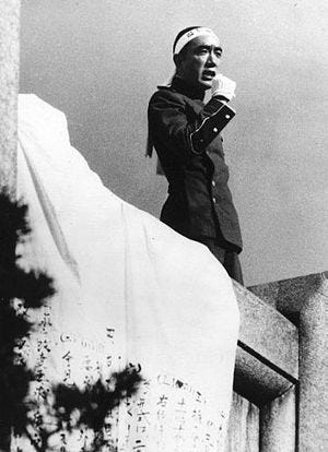 Mishima Yukio talking from a balcony