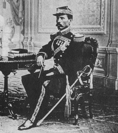 a black and white photo of a young Colonel Porfirio Díaz sitting in uniform with a sword