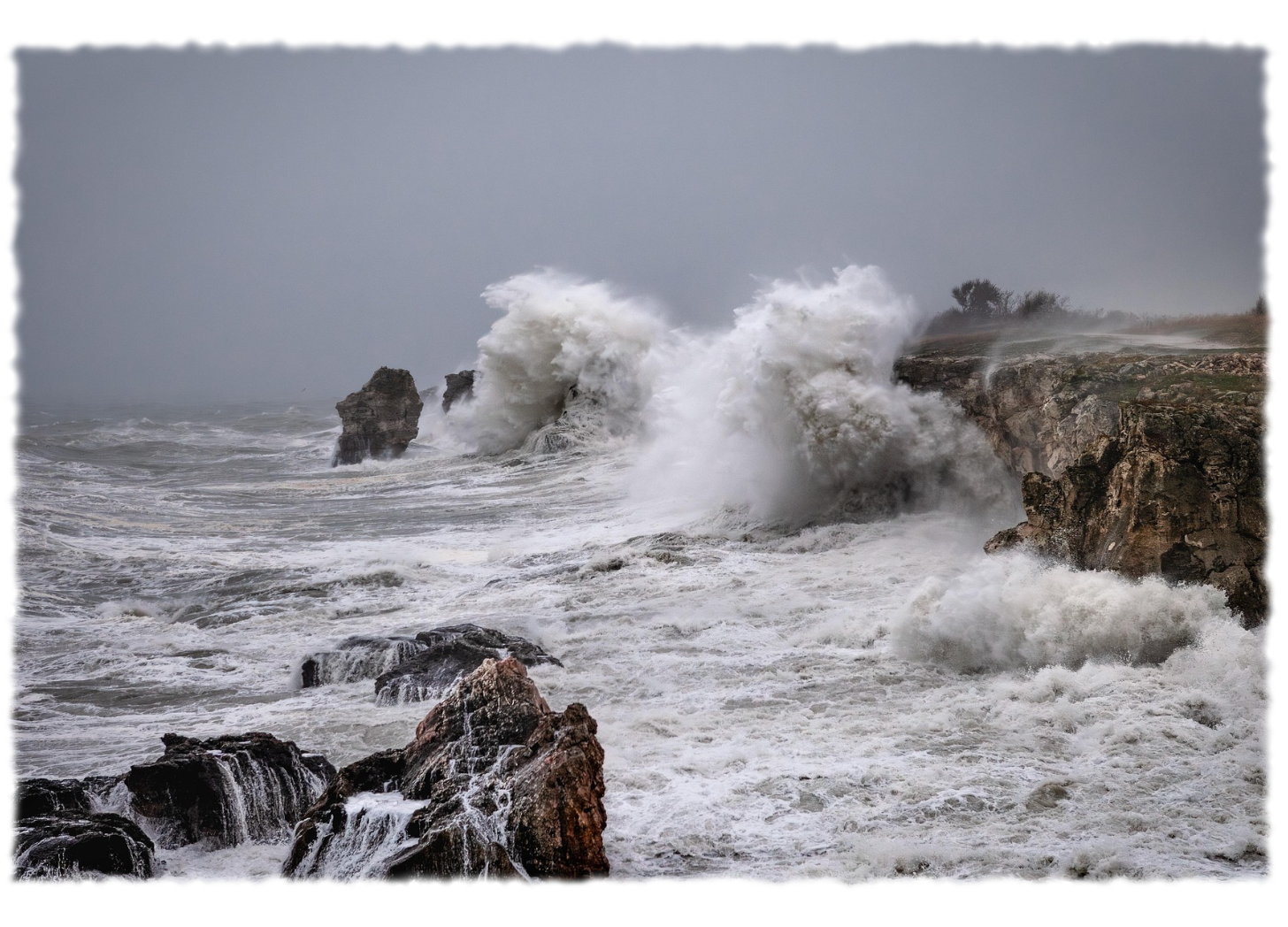 Ocean waves crash on a rocky shoreline