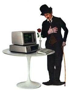 IBM PC on a table with Charlie Chaplin character looking at it in an advertisement