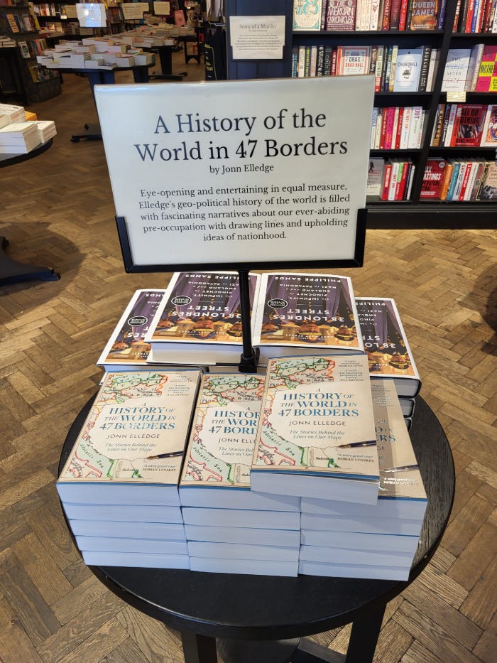 a table of my book with a sign describing it as "eye-opening" and "fascinating"