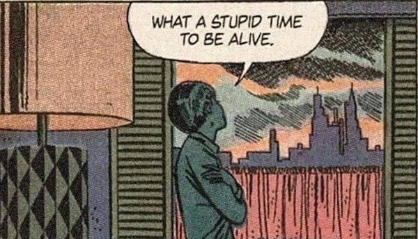 "What a stupid time to be alive." Comic panel of a woman looking out a window, arms crossed.