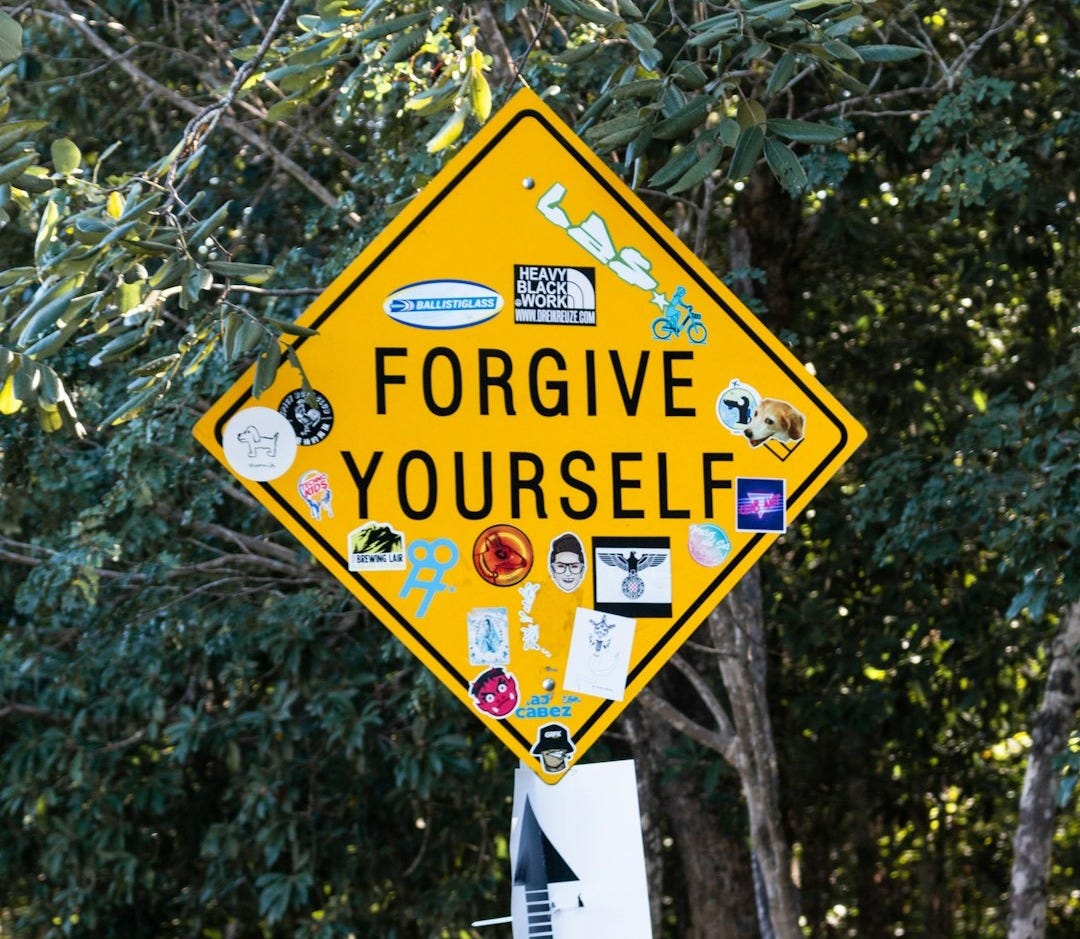 a yellow street sign with stickers on it a yellow street sign with stickers on it