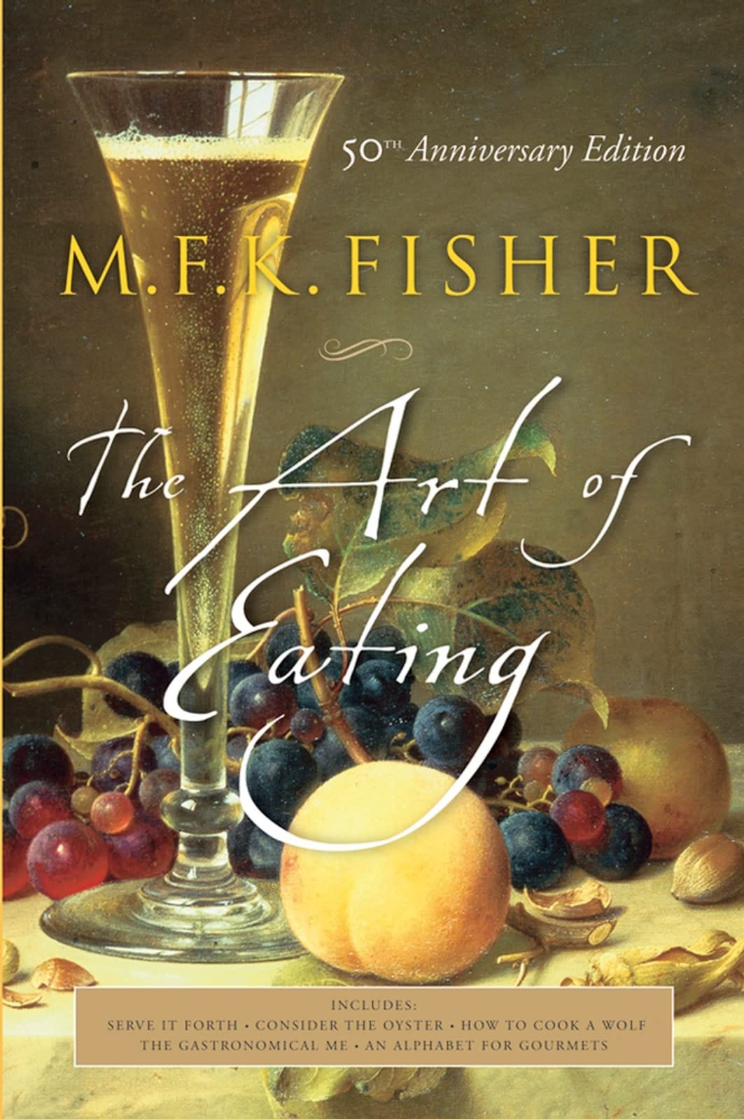 Cover of THE ART OF EATING. A glass of champagne with grapes, a peach, cracked nut shells.