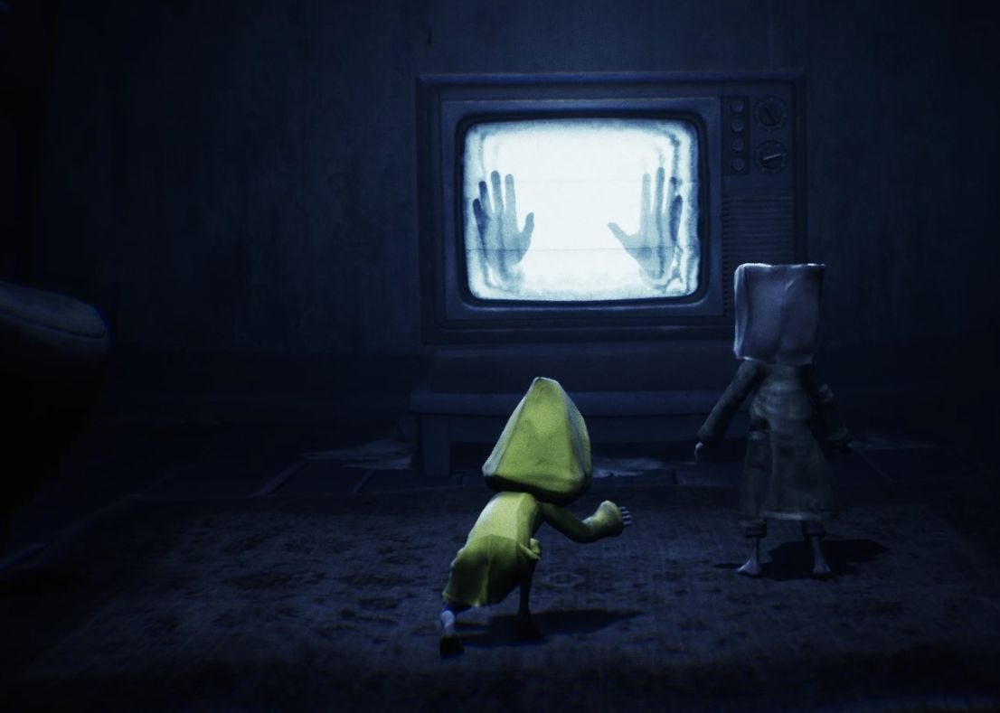 A screenshot of Mono staring into the TV. Hands appear to be pressed to the screen of the TV from the inside. In the foreground, we see Six reaching for Mono's hand to pull him away.