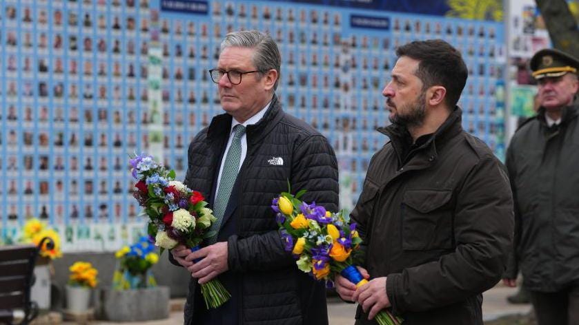 Ukrainian President Volodymyr Zelensky lays flowers with Prime Minister Keir Starmer in Kyiv