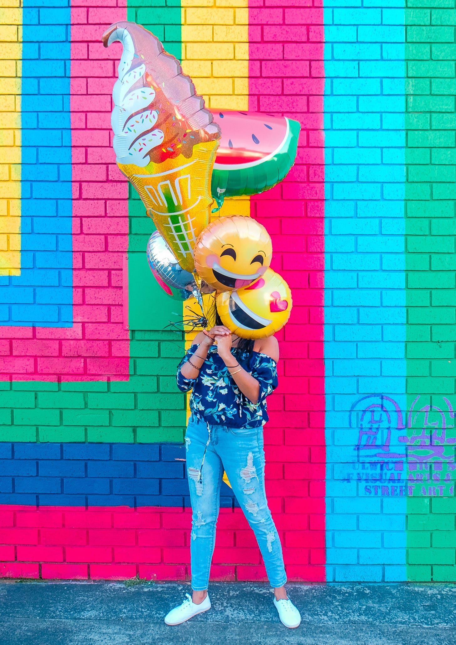 girl with smiley emoji balloons girl with smiley emoji balloons