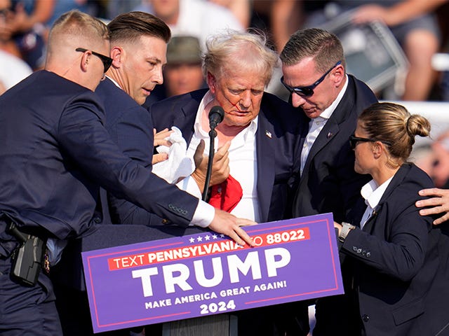 Republican presidential candidate former President Donald Trump is helped off the stage at