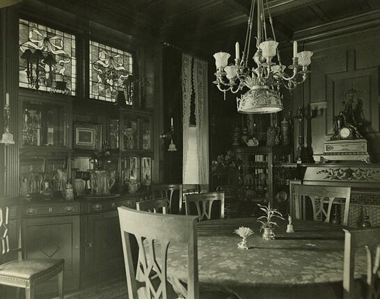 black and white photo of a dining room with stained glass