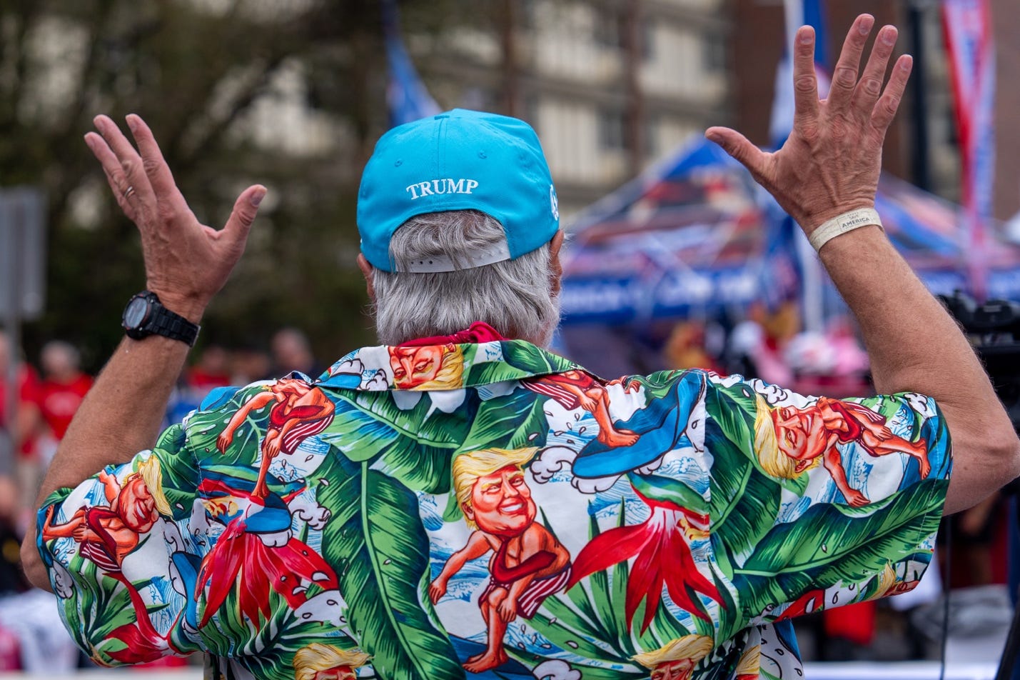 A person wearing a blue hat and a hawaiian shirt

Description automatically generated