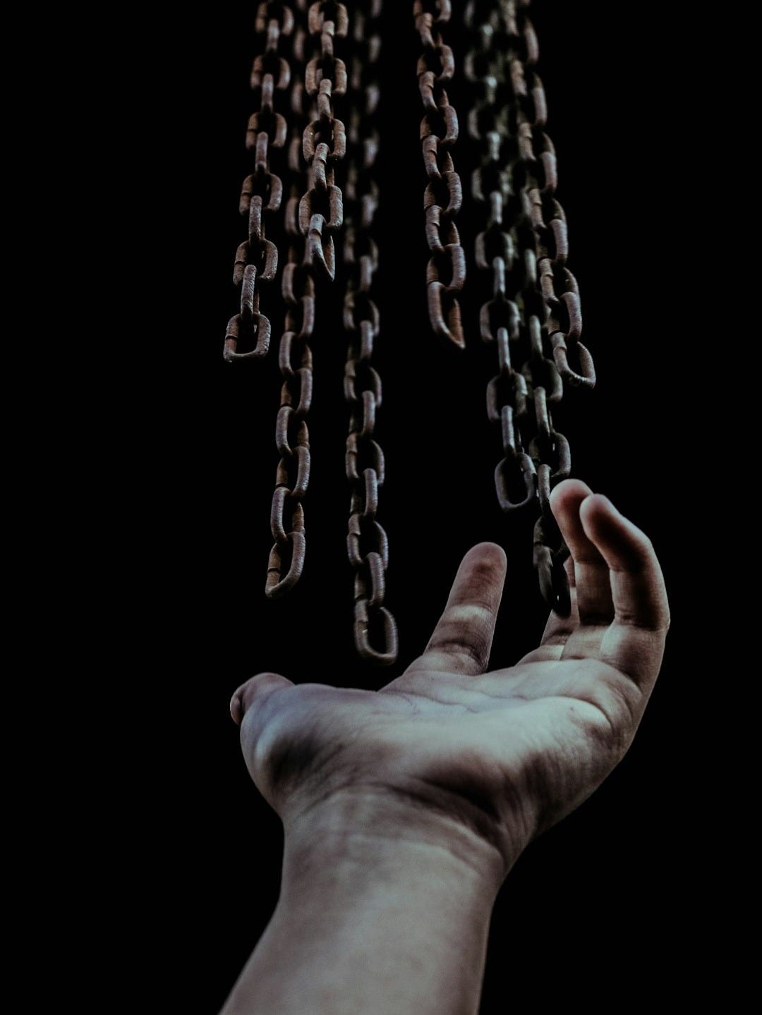 man's hand and chains