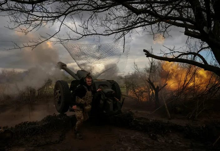 Ukrainian service members fire a howitzer D30 at a frontline near the city of Bakhmut.