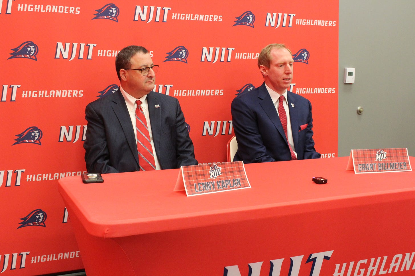 New coach Grant Billmeier (right) speaks to reporters alongside NJIT athletic director Lenny Kaplan on April 20, 2023. (Photo by Adam Zielonka)