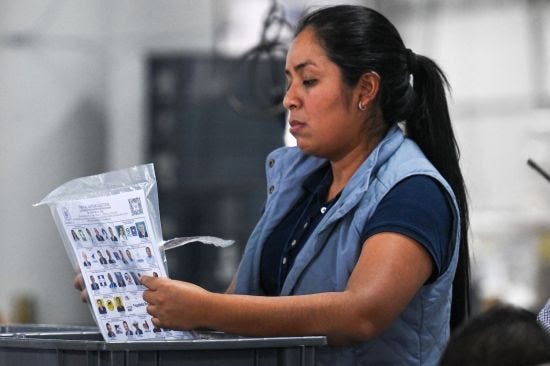 An electoral employee arranges ballots in Guatemala City.
