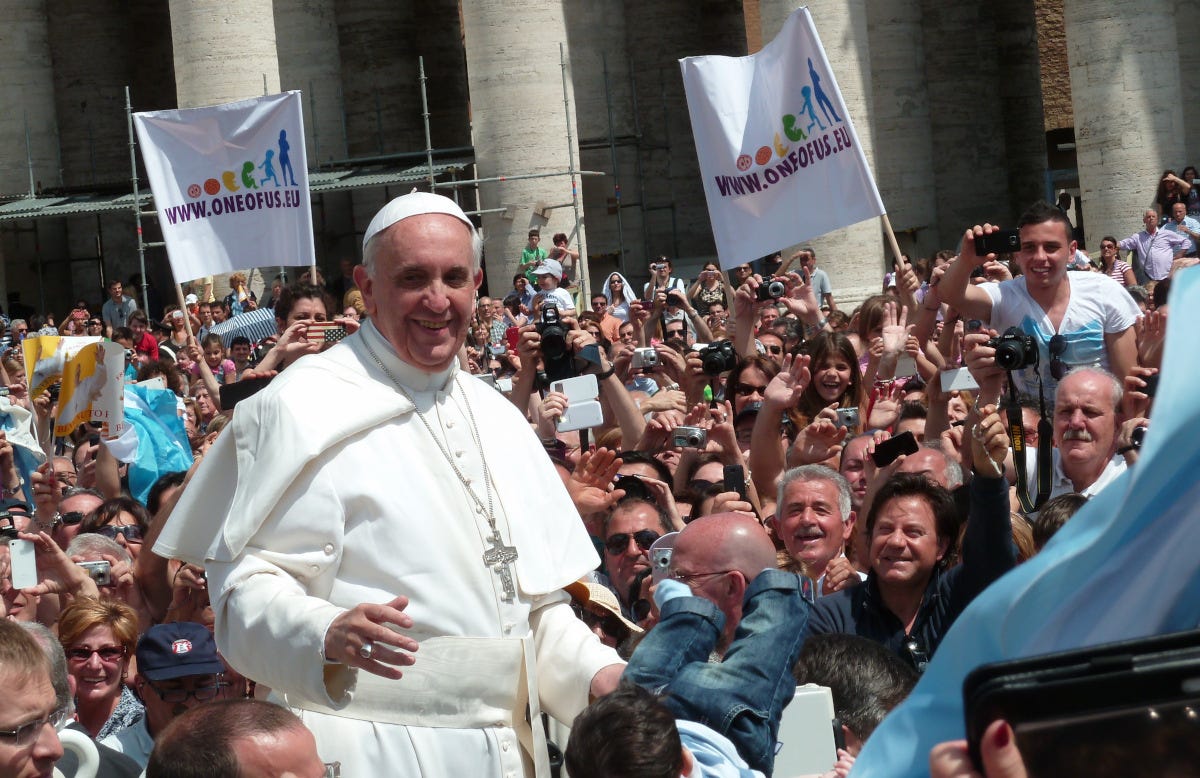 Pope Francis in a large crowd of people Pope Francis in a large crowd of people