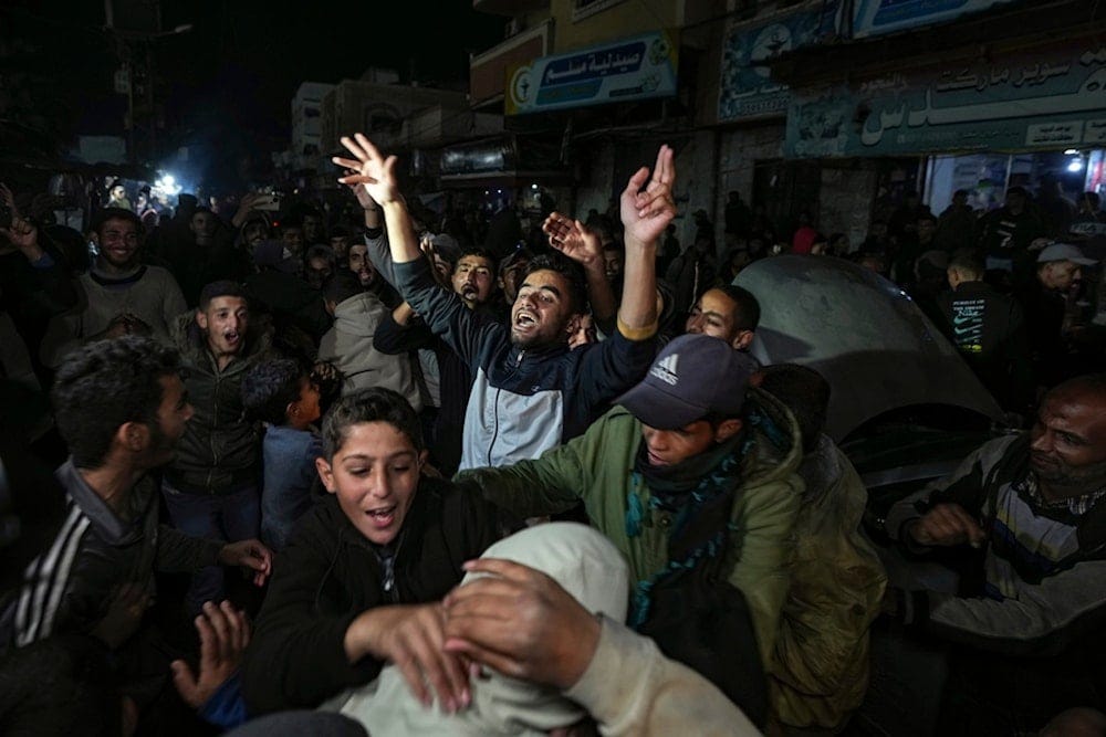 Palestinians celebrate the announcement of the Gaza ceasefire deal in Deir al-Balah, central Gaza Strip, Wednesday, January 15, 2025 (AP)