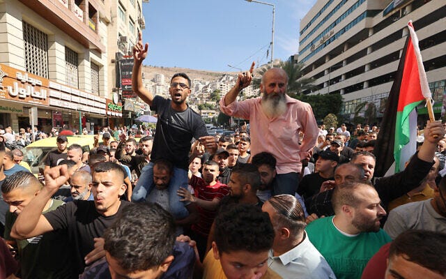 Palestinians in the West Bank city of Nablus celebrate on October 7, 2023, after Hamas terrorists infiltrated Israel from the Gaza Strip and launched a brutal large-scale attack on Israeli towns and cities. (Photo by Jaafar ASHTIYEH / AFP)