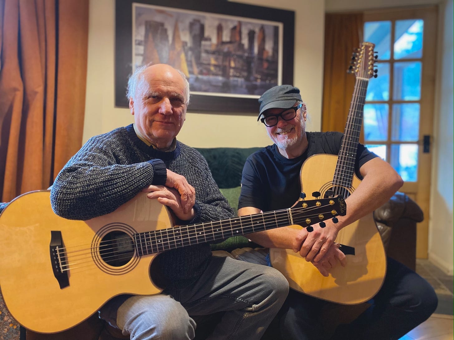 Roger Bucknall and Simon Campbell pictured holding six and 12 string Fylde Guitars in Roger’s home near Penrith