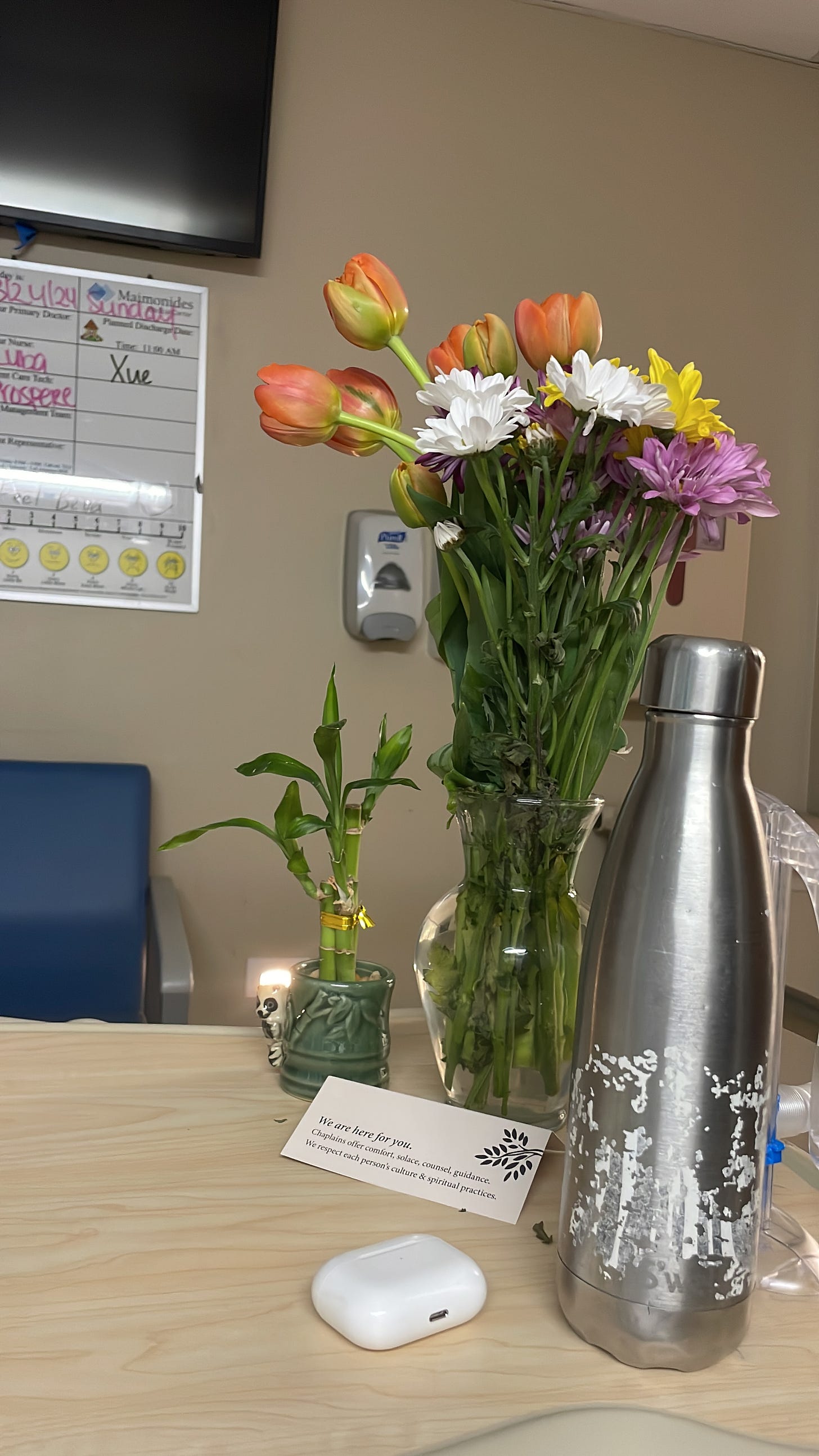 Flowers and bamboo plant on a table in a hospital room