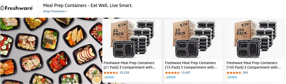 A dynamic display of black meal prep containers filled with colorful, healthy meals, alongside product boxes showing stacks of black three-compartment containers.