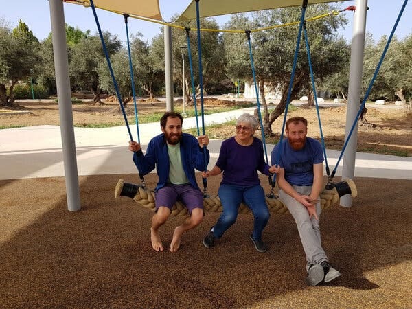 Silver with her sons on a swing.