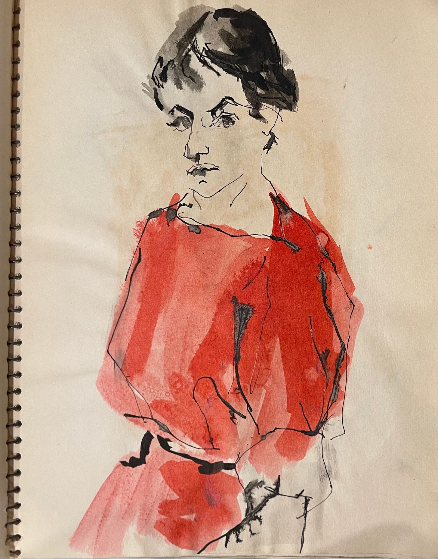 A spiral notebook page features a portrait of a woman in red, black, watercolor, and maybe ink. She looks fierce, with arched dark eyebrows and short dark hair, her face at a three-quarter angle. The left side of the face is undefined, and she wears a red dress.