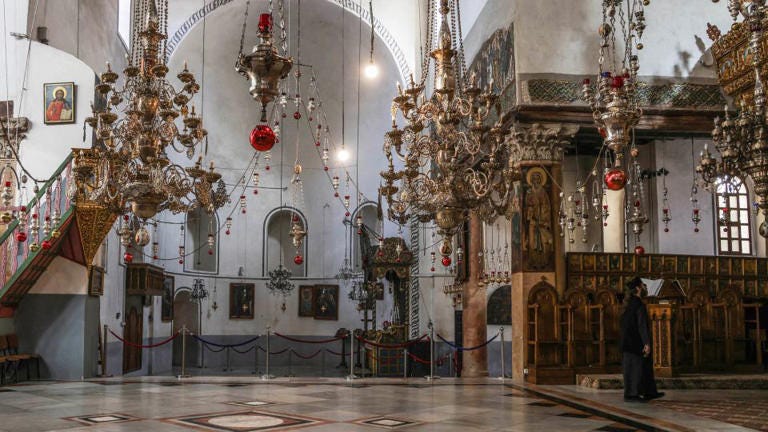 The Church of the Nativity, a World Heritage site, is largely empty this year with Christmas celebrations on hold. - Faiz Abu Rmeleh/dpa/Reuters