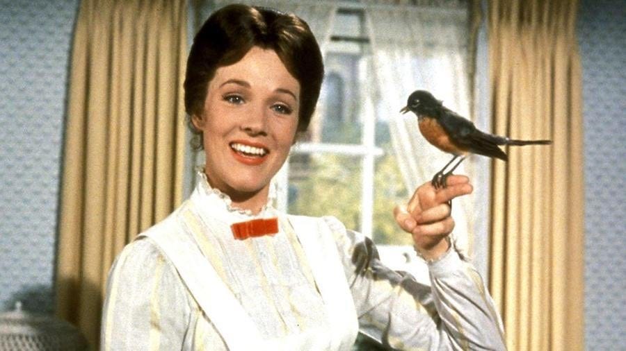 Julie Andrews as Mary Poppins with a (fake) American Robin sitting on her finger.