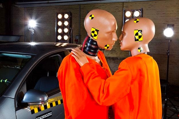 Crash dummies engaged in an intimate moment. 