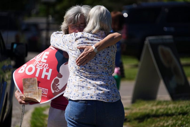 Mari Schoen hugs a fellow supporter as they celebrate the overturning of Roe v. Wade outside a Planned Parenthood clinic in Columbus in June.
