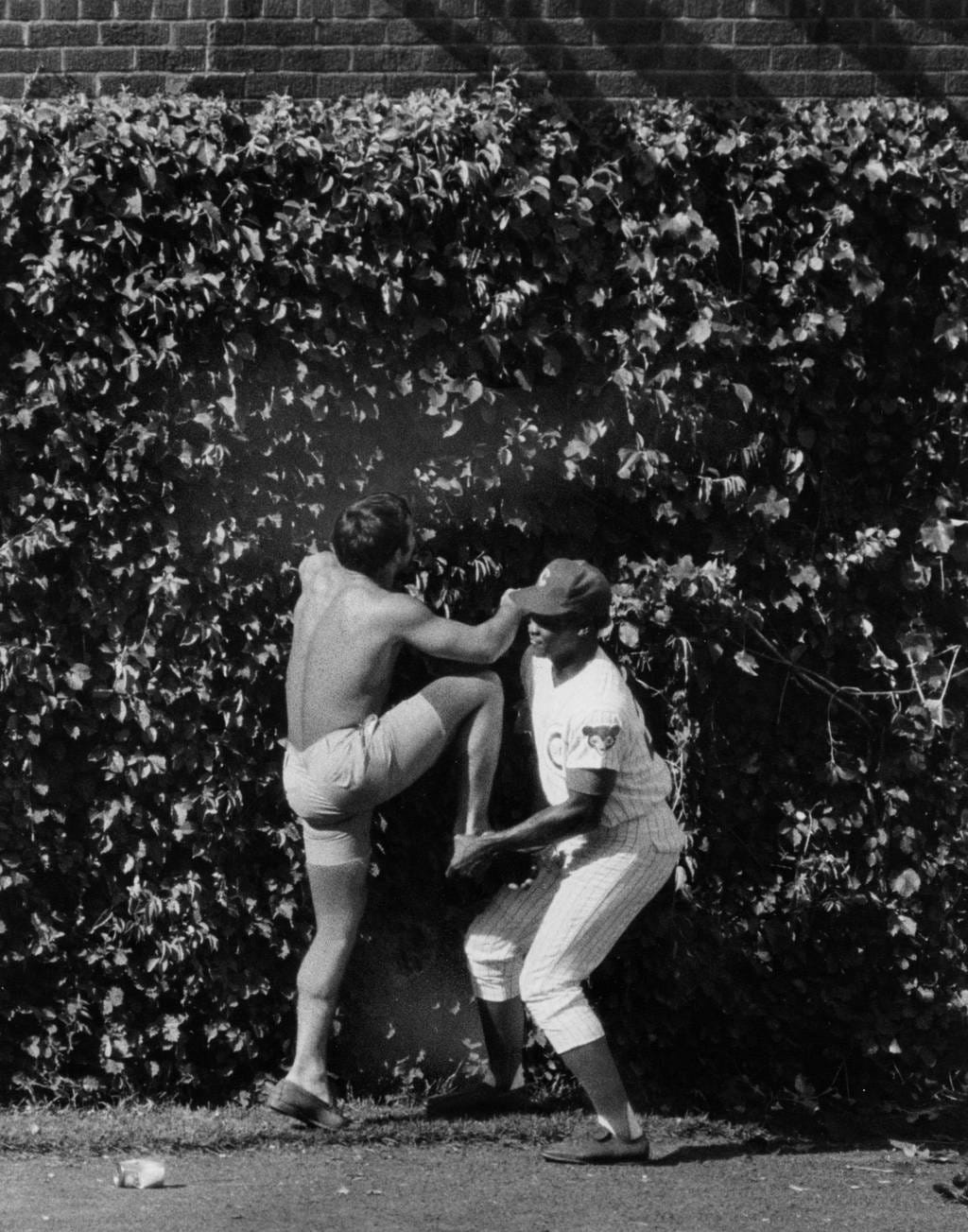 Cubs outfielder Willie Smith gives a fan a boost.