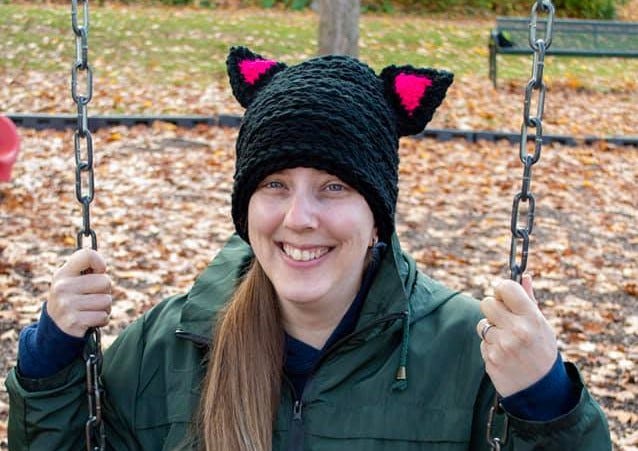 Patricia wearing a kitty cat hat she made