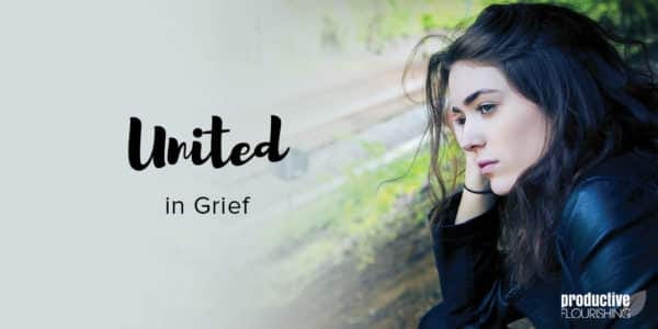 A woman with dark hair rests her head on her hand, and looks off into the distance. Text Overlay: United In Grief