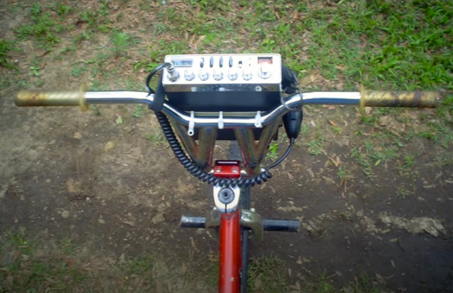 An old photo of a box with trick nuts and a CB on the handlebars.