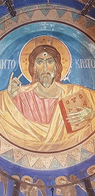 A mural depicts an icon of Christ with a bullet hole in his forehead.