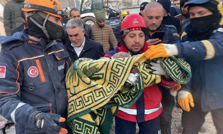 Two siblings, seven-month-old Omer and nine-year-old Muhammed Acar, are rescued in Adiyaman province, Turkey, 58 hours after the earthquake hit. Photograph: Anadolu Agency/Getty Images
