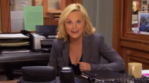 Leslie Knope looking excited and anticipatory