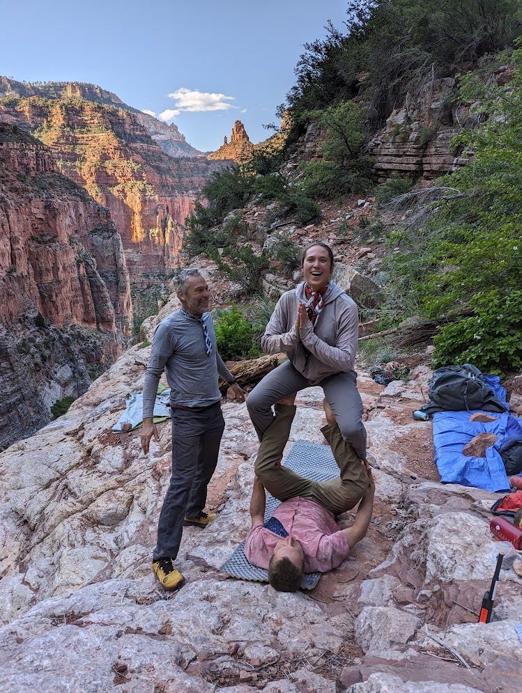 Alex and Sam doing acro yoga. Alex basing, Sam flying, in the throne post