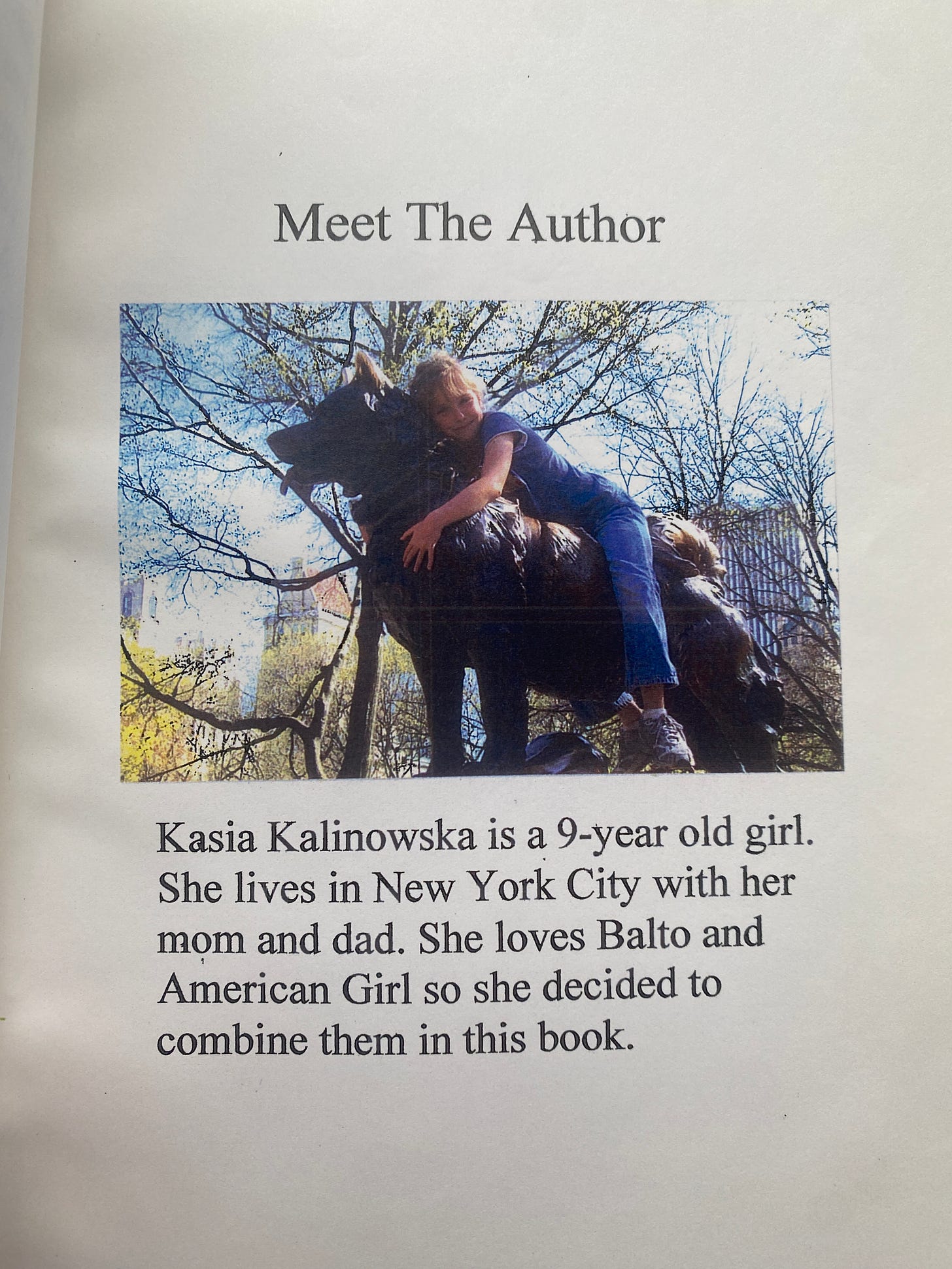 An author bio below a photo of a young girl on a statue of a dog. The author bio reads: Kasia Kalinowska is a 9-year-old girl. She lives in New York City with her mom and dad. She loves Balto and American Girl so she decided to combine them in this book.