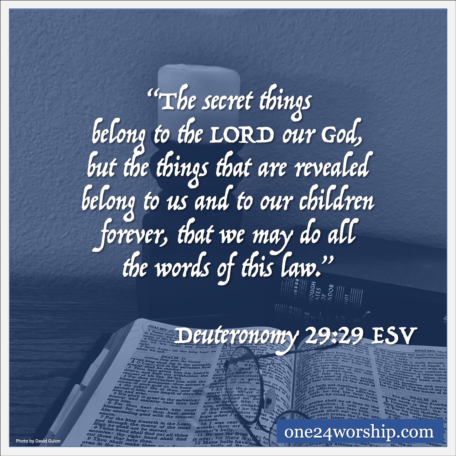 Image of an open Holy Bible with glasses set upon, and two books and a candle beside with Deuteronomy 29:29 quote superimposed.