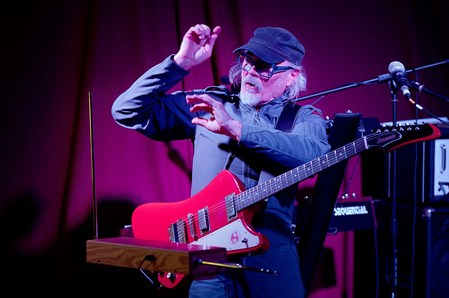 Man with cap and red guitar playing a theremin - Simon Campbell at The Muse, Brecon