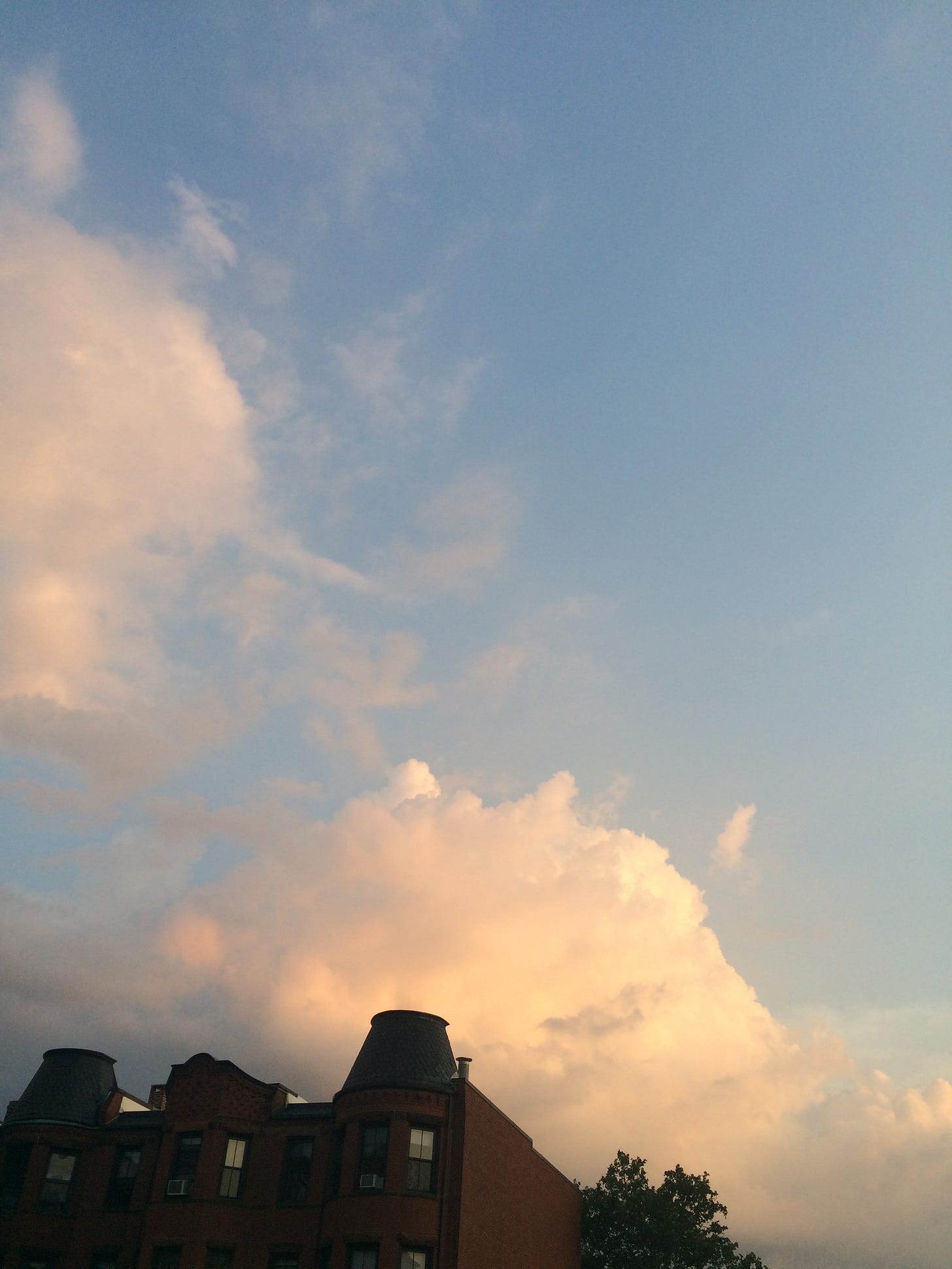 Some clouds in the sunset above buildings on Mass Ave